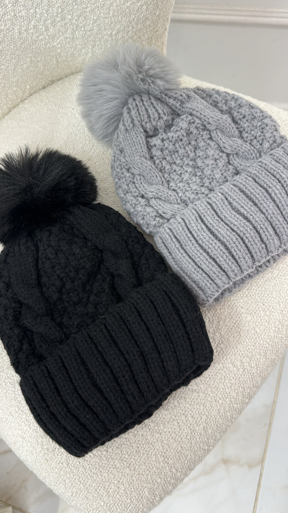 REMI black knit pom pom hat
