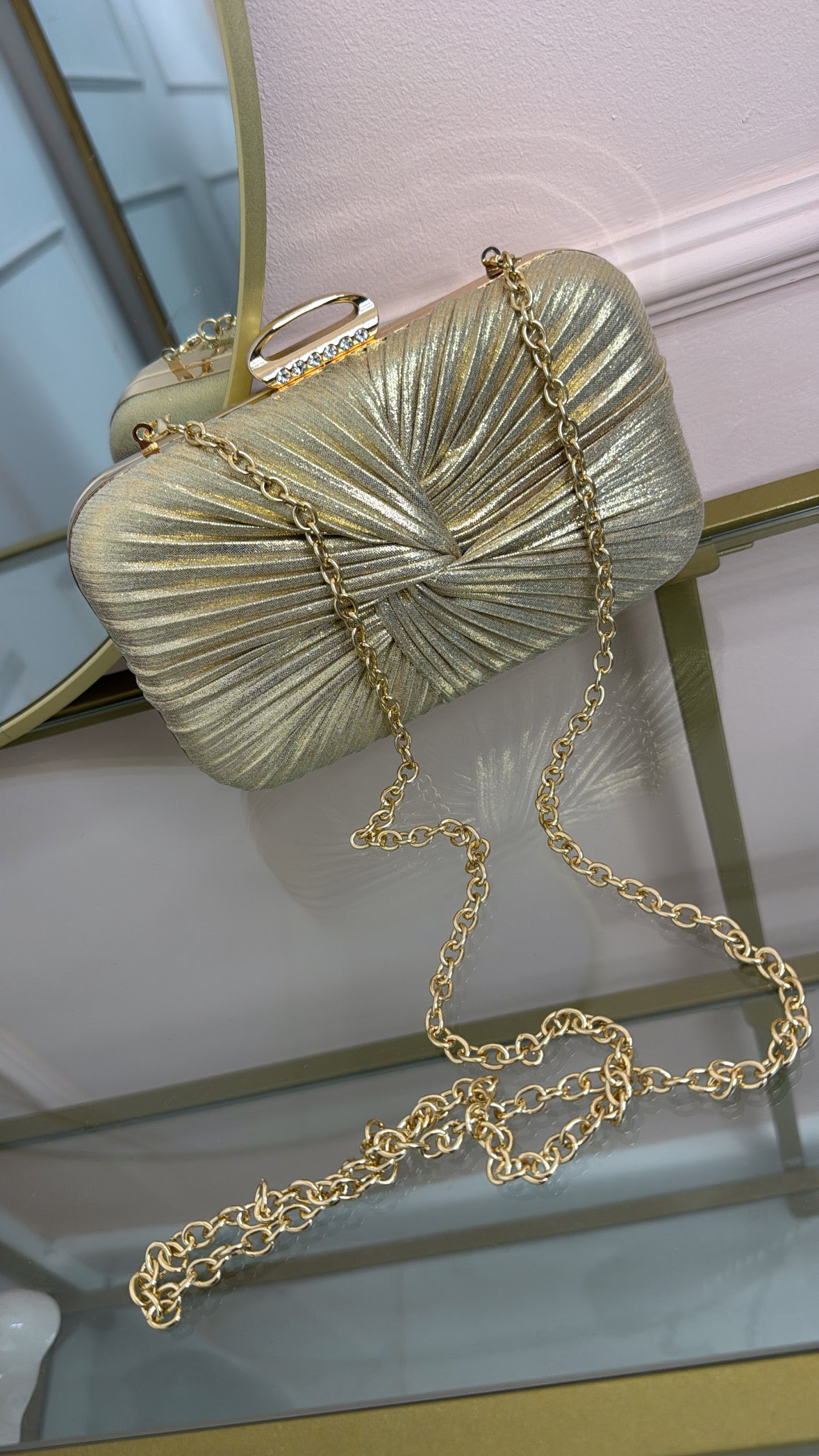 ISLA gold twist clutch bag